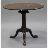 A George III and later mahogany circular tip-top wine table,fitted with a bird cage mount, raised on