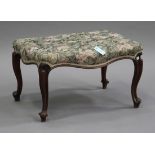 A Victorian walnut footstool with overstuffed floral seat, on carved cabriole legs, height 40cm,