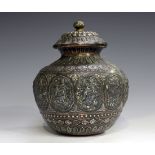 A 19th century Indian copper jar and cover, the reeded lid and bulbous body overlaid in silver and