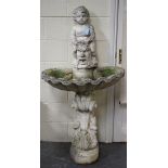 A 20th century cast composition garden fountain with putti and foliate mask surmount above a scallop