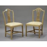 A set of eight 20th century reproduction pale hardwood pierced splat back dining chairs with drop-in