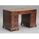 A 20th century reproduction mahogany twin pedestal desk, fitted with nine drawers, on bracket