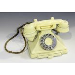 A cream Bakelite telephone, the receiver detailed '164-55', the base printed '1/232L 555/2', with