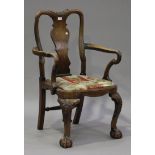 A 20th century George I style walnut shepherd's crook armchair with vase shaped splat back, the