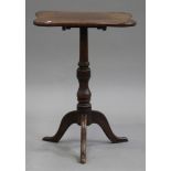 A Victorian oak tip-top wine table, the shaped top raised on a turned column and tripod cabriole