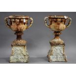 A pair of 20th century white painted cast iron garden urns, each shaped body decorated with trailing