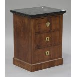A 19th century French Empire style mahogany chest of three drawers, the black marble top above three