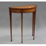 A George III satinwood demi-lune table, the mahogany crossbanded top above a line inlaid frieze,