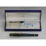 A Waterman Paris fountain pen with a green marbled and black plastic casing, boxed. Buyer’s