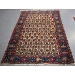 A Hamadan rug, North-west Persia, early 20th century, the ivory field with an overall lattice of