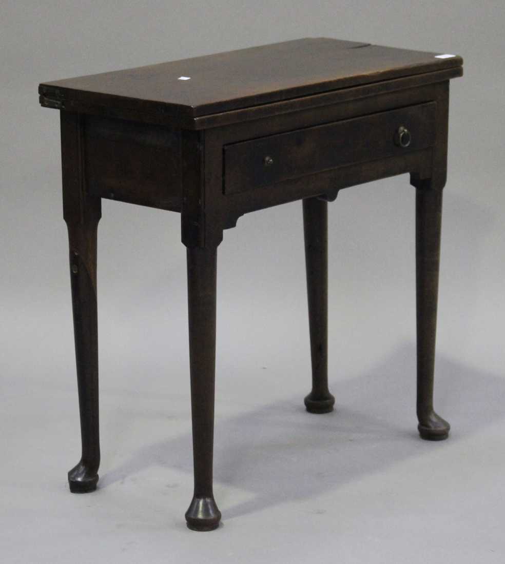 A George II red walnut fold-over tea table, the rectangular top above a single frieze drawer, on