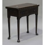 A George II red walnut fold-over tea table, the rectangular top above a single frieze drawer, on