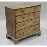 A George III oak chest of two short and three long drawers, raised on bracket feet, height 98cm,