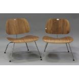 A pair of late 20th century bent plywood Eames style lounge chairs, raised on chromium plated