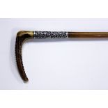 A late Victorian silver mounted rhino horn riding crop with an antler handle, the tapering shaft