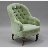 A Victorian salon armchair, upholstered in green velour, raised on turned legs and castors, height