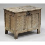 An 18th century oak panelled coffer of small proportions, the hinged lid and sides with chip