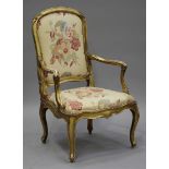 An 18th century Italian giltwood showframe armchair with an upholstered seat and back, raised on