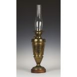 A late Victorian Aesthetic period brass table oil lamp, the burner and reservoir above a tapering
