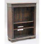 A late Victorian oak bookcase, the frieze caved with lunettes above four adjustable shelves,