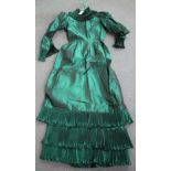 A mid-20th century green metallic satin lady's dress by Jean Allen, London, size 12. Buyer’s Premium