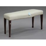 A 20th century George III style mahogany window seat with overstuffed cream upholstered seat, on