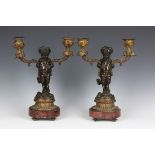 A pair of early/mid-19th century French brown and gilt patinated cast bronze twin light