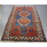 A Kazak rug, West Caucasus, late 19th/early 20th century, the blue field with a pair of stepped