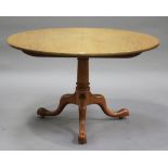 A 20th century reproduction mahogany circular tip-top breakfast table, raised on a turned column and