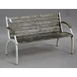 A 20th century white painted cast metal garden bench, the angular ends supporting a wooden seat