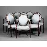 A set of eight George III mahogany armchairs, in the manner of William Linnell, each oval back