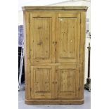 A 20th century pine floor-standing corner cabinet, the moulded pediment above four panelled doors,