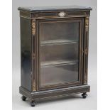 A late 19th century ebonized pier cabinet with gilt metal mounts, the moulded top above a Sèvres