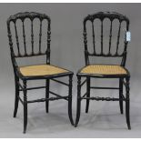 A pair of Victorian ebonized spindle back bedroom chairs, painted with flowers and leaves, the