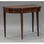 A George III mahogany card table, the shaped top raised on square tapering block legs, height