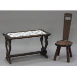A 20th century carved walnut spinning chair and a stained softwood table, inset with ten Delft