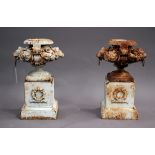 A pair of 20th century white painted cast iron garden urns, each low bellied body decorated with