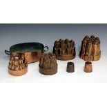 A collection of mainly late 19th century copper jelly moulds, including three Benham & Froud moulds,