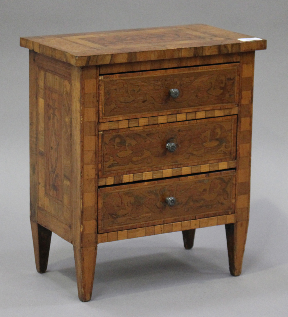 An 18th century style walnut and inlaid diminutive chest of three drawers, on square tapering