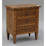 An 18th century style walnut and inlaid diminutive chest of three drawers, on square tapering