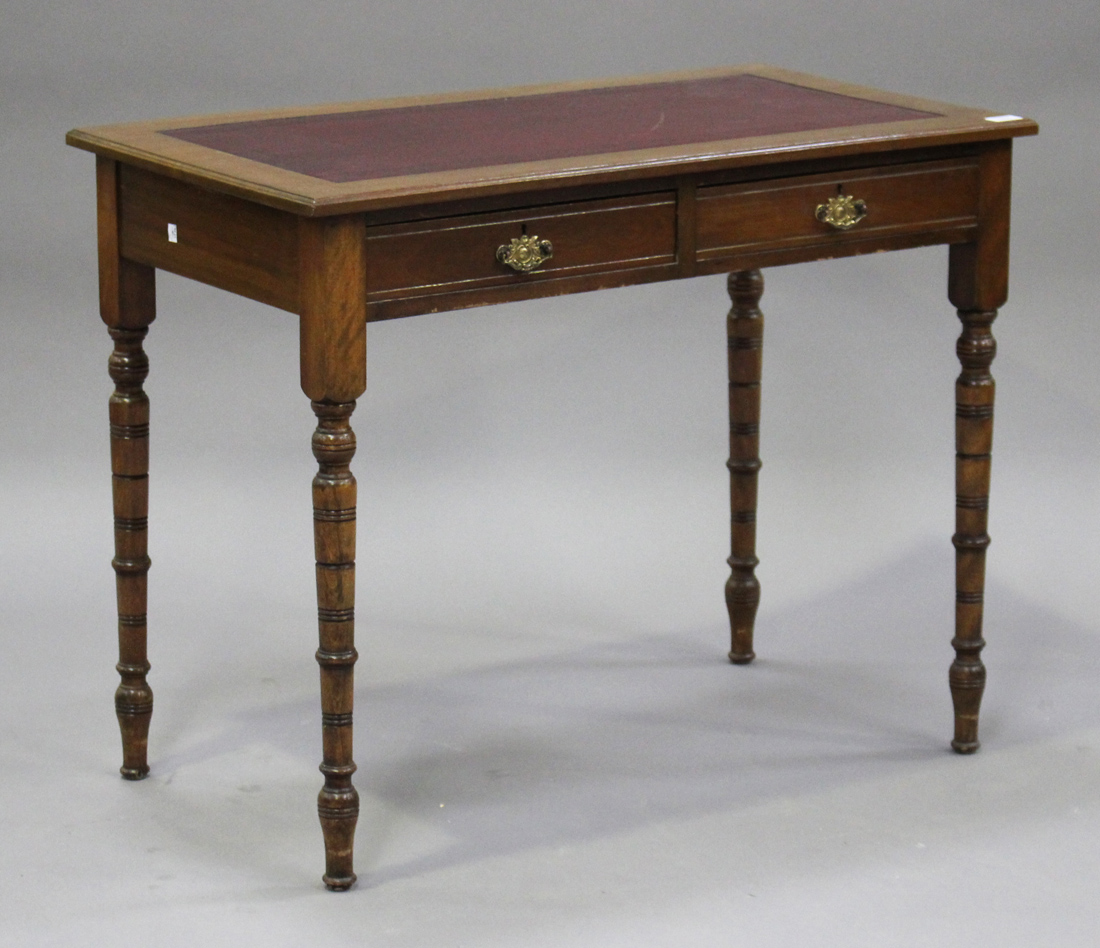 A late Victorian walnut writing table, fitted with a gilt-tooled red leather writing surface above