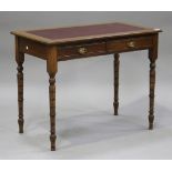 A late Victorian walnut writing table, fitted with a gilt-tooled red leather writing surface above