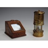 A late 19th century carved softwood pocket watch holder of rectangular form with sloping glazed