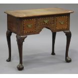 A 19th century oak lowboy, the canted rectangular top above three frieze drawers with chequer banded
