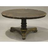 A William IV rosewood circular tip-top breakfast table, the moulded edge carved with leaf scrolls,