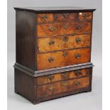 An early 18th century walnut chest-on-chest, the moulded pediment above three short and three long
