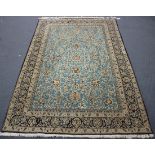 A Kashmir rug, mid-20th century, the light blue field with overall scrolling vines and palmettes,