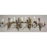 A pair of late 19th/early 20th century silvered cast bronze twin branch wall lights, the shaped knop