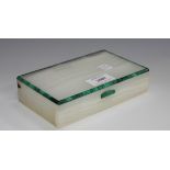 An Art Deco white onyx and malachite banded rectangular cigarette box, the gilt metal hinged lid
