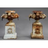 A pair of 20th century white painted cast iron garden urns, each low bellied body decorated with